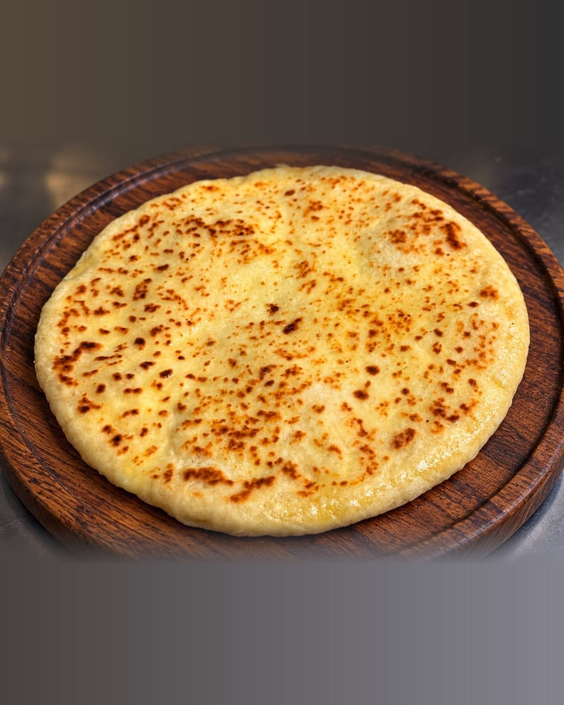 Imeruli Khachapuri — The classic round cheese bread, perfect for sharing.