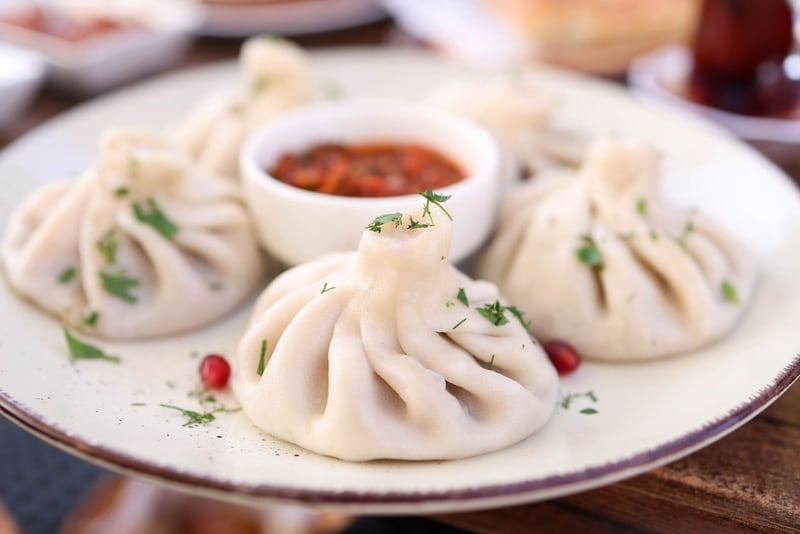 Khinkali (5 pc) — Juicy soup dumplings — hold by the knot, bite, and sip the broth.