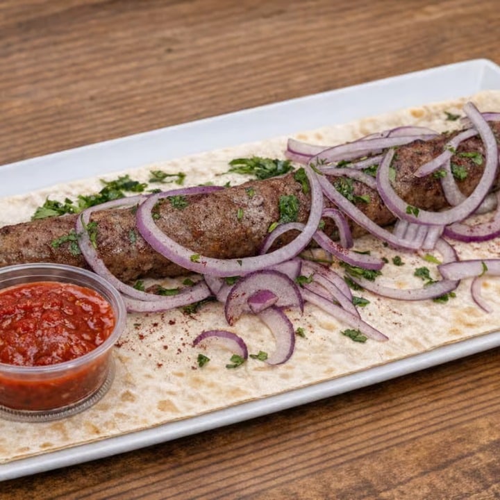 Beef Lula Kebab — Spiced beef kebab on lavash with homemade sauce.